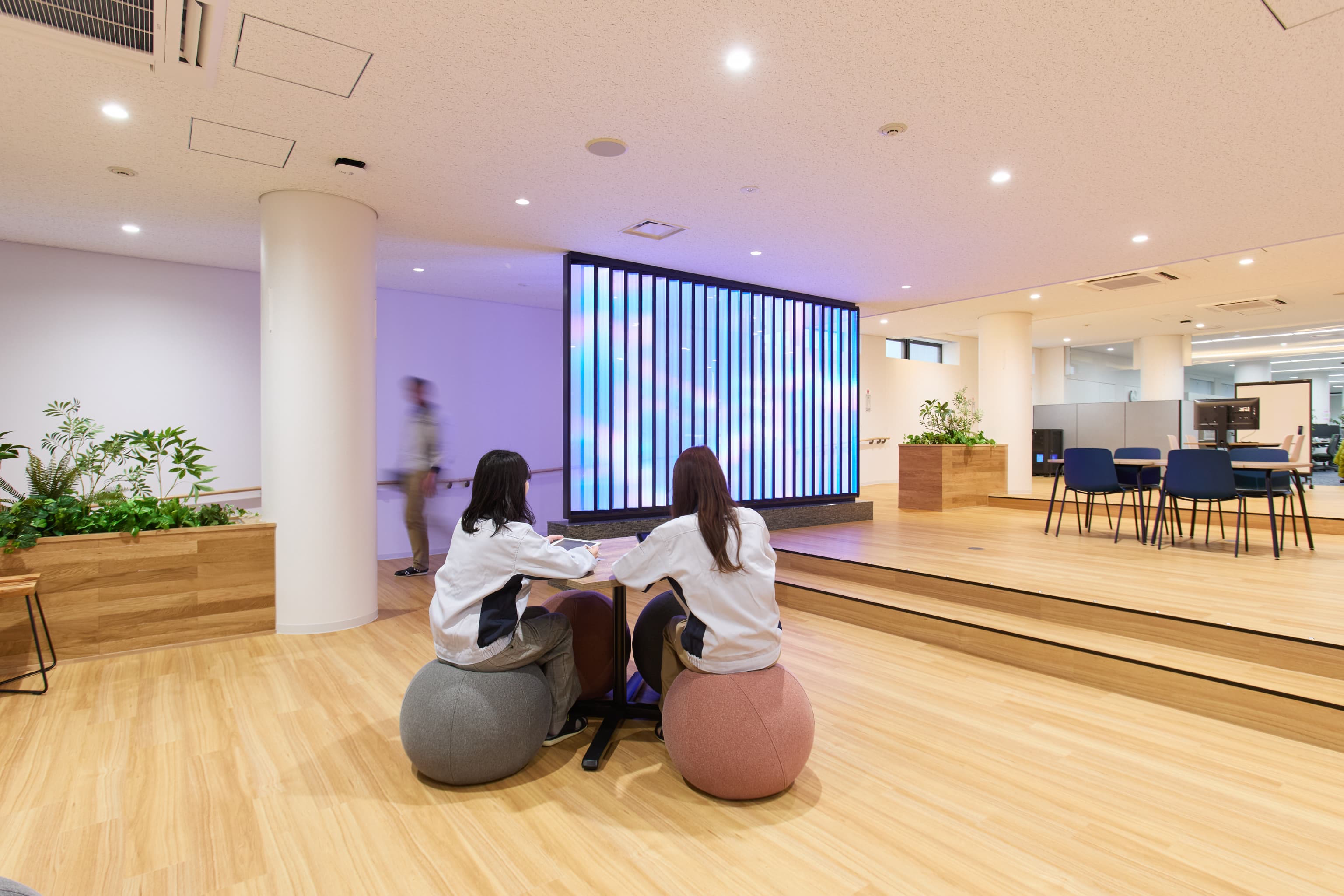 日東電工株式会社 様の事例写真／[2F Connect（交流エリア）]新しい光の表現を生み出すNittoの光制御技術「RAYCREA™」が設置され、美しい色が周囲を華やかに彩ります。来訪者や就活生がこのエリアを通れば、高い技術力がダイレクトに伝わることでしょう。