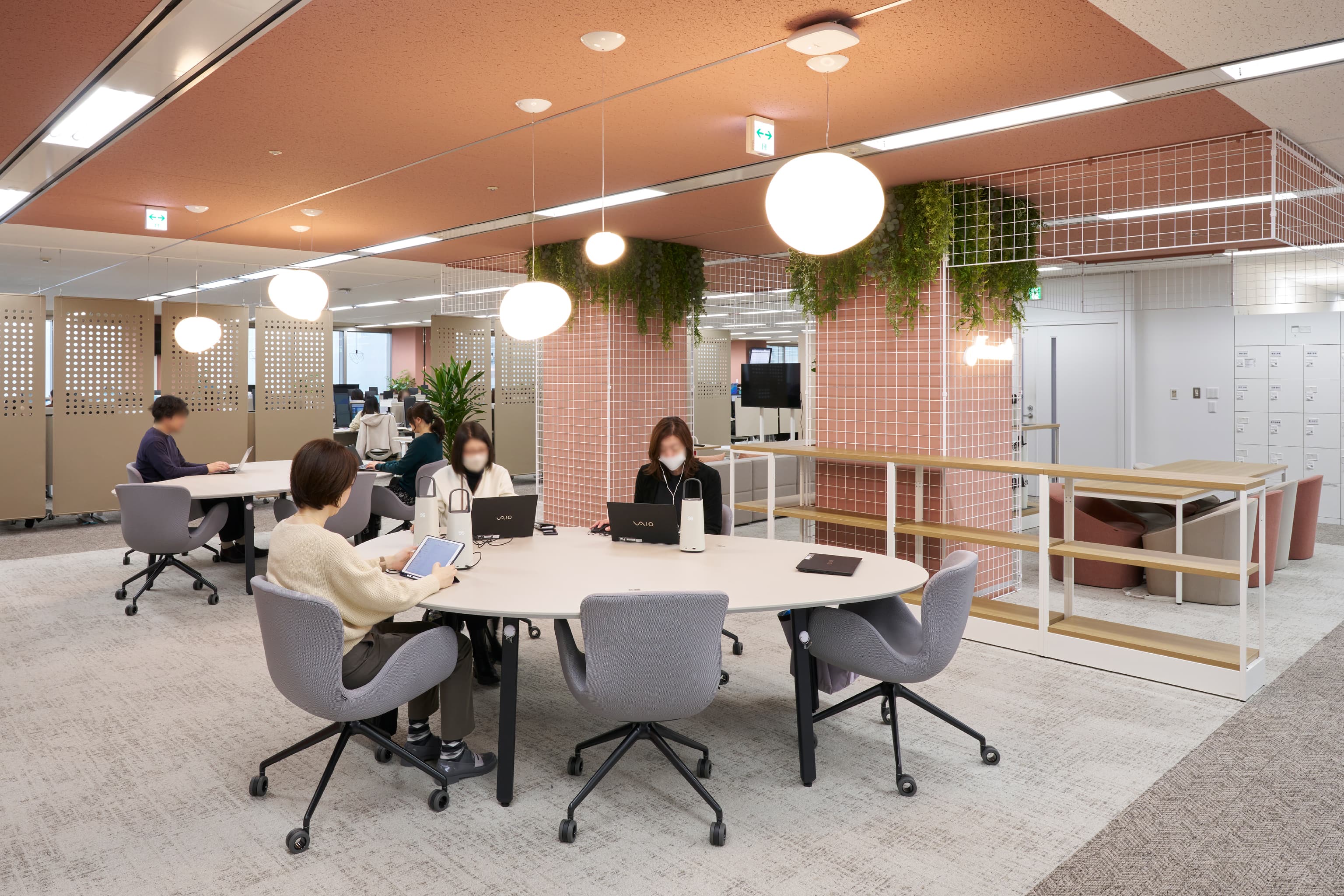 株式会社JALナビア 様の事例写真／[18F Nexus]執務席としても利用されるオープンエリア。柱を囲うメッシュパネルに取り付けられた植栽が、居心地が良くコミュニケーションを取りやすい空間を演出します。